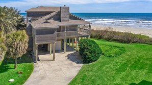 A two-story house with a balcony overlooking the beach. - Beachfront Beauty with Huge Deck & Stunning Views (Galveston)