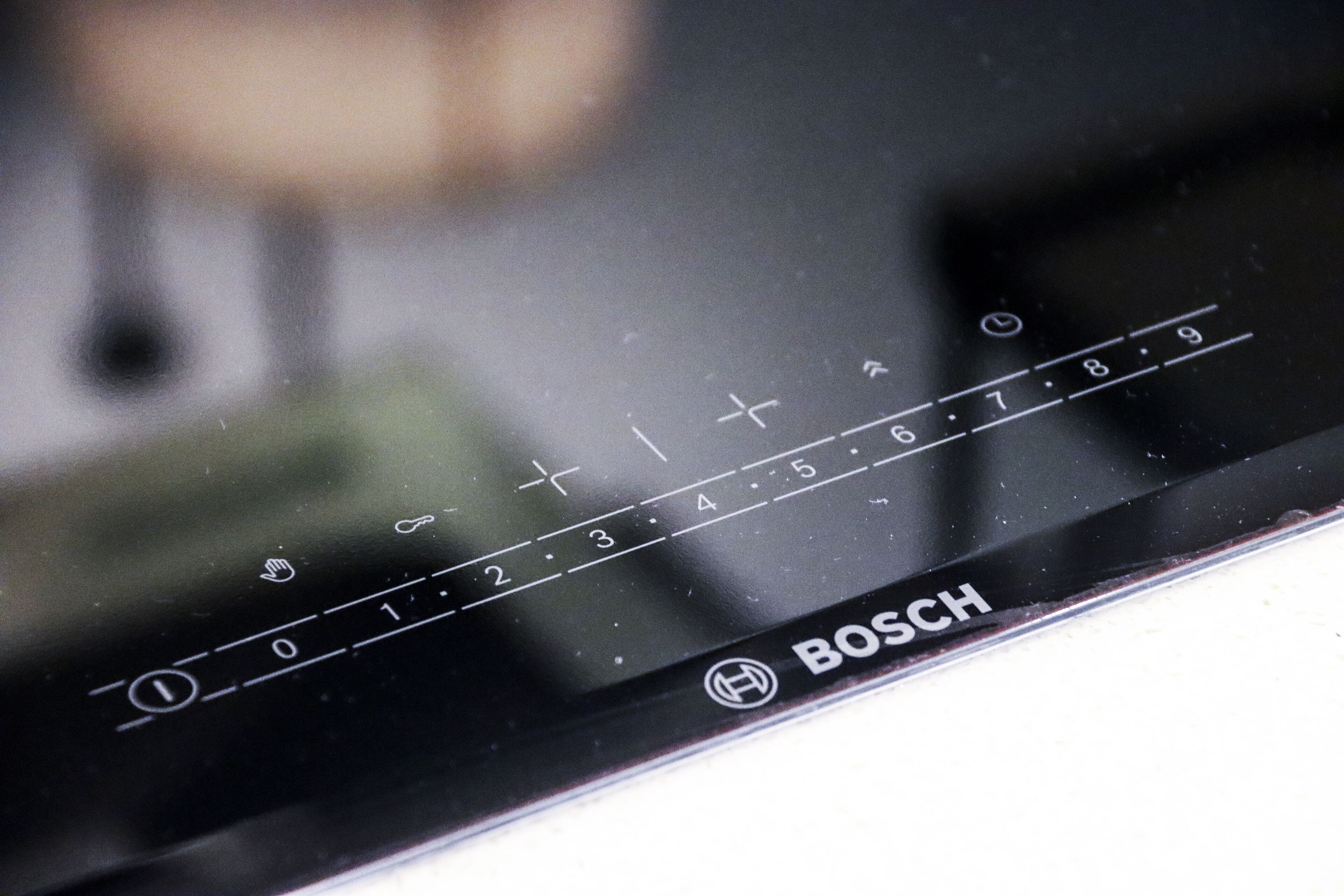 A close-up of a digital interface with numerical and directional controls, likely part of a kitchen appliance.