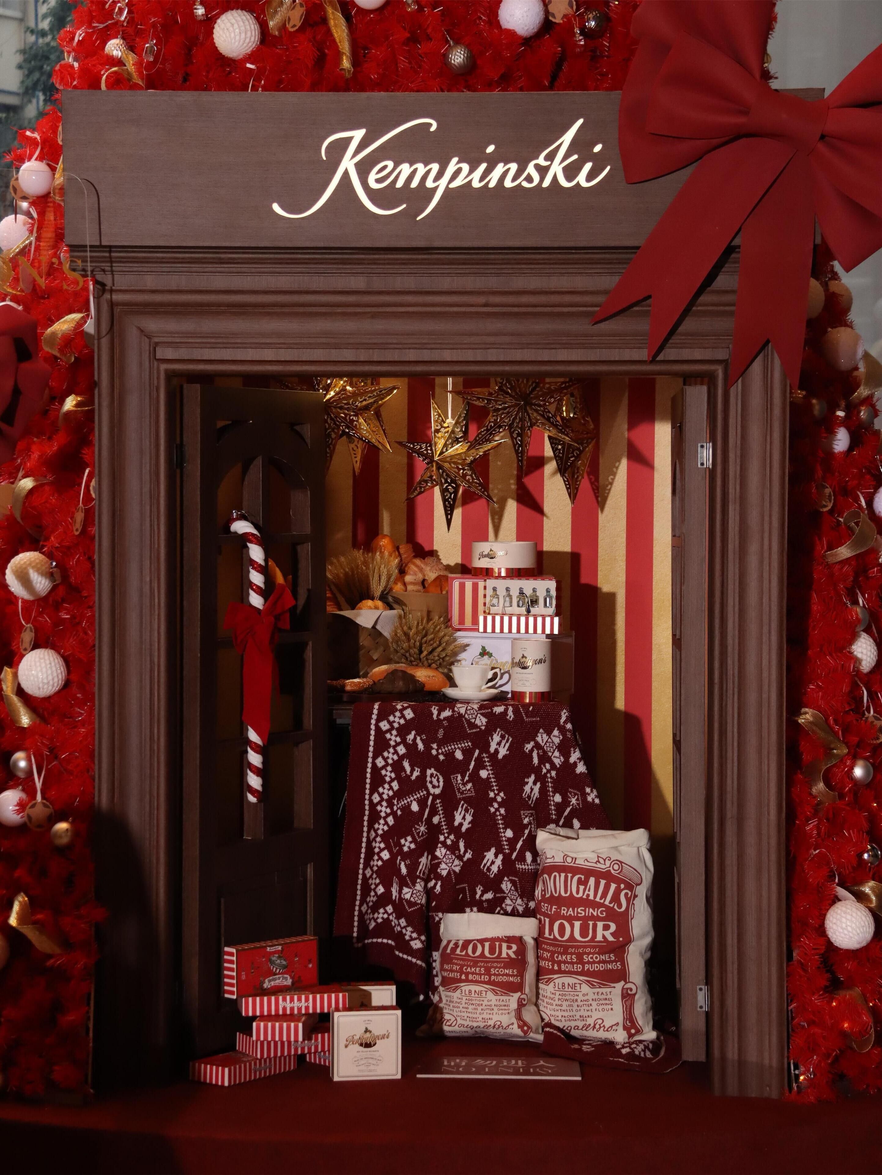 A festive display with a sign reading "Kempinski" and various holiday decorations.