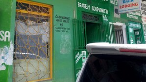 A building with green walls and a metal roof. There are signs for 'TRU-NORTH LTD' and 'ALHABIB 2 MPESA'. - Dgk Lodge (Naivasha)