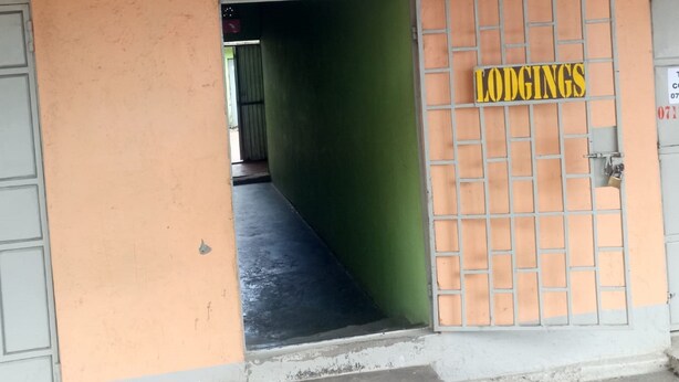A building entrance with a sign for 'INNS LODGING' and another sign for 'LODGINGS'. - Inns Lodge (Naivasha)