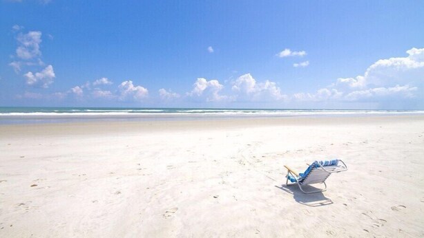 A beach with a single beach chair and a clear sky. - Artist Retreat, 2 Bedrooms, Summer Haven, 3 Houses to Beach, Sleeps 7 (St. Augustine)