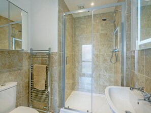 A modern bathroom with a glass-enclosed shower, a white sink, and a towel rack. - 2 bedroom accommodation in Mundesley, near North Walsham (Mundesley, near North Walsham)