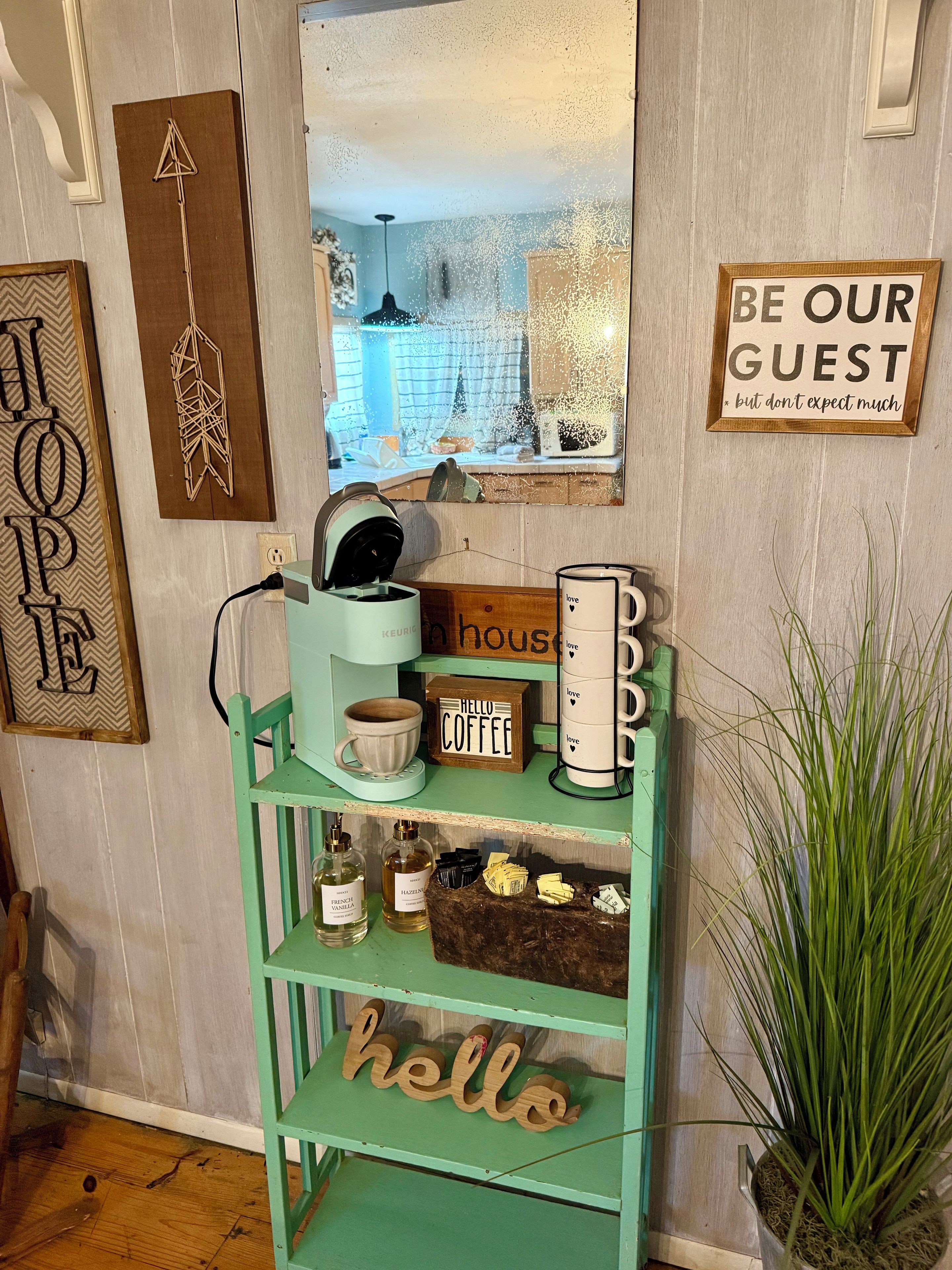 A coffee station with a sign that reads 'HELLO COFFEE' and a 'BE OUR GUEST' sign.