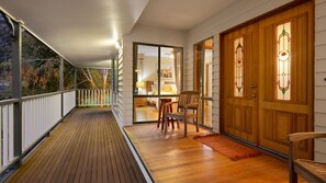 Enter a serene space with a comfortable bed, chair, and table.