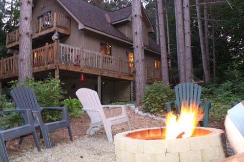 Stunning two-story home in the trees w/ a firepit, furnished deck, & balcony