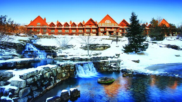 A lodge with a stone waterfall and snow-covered landscape. - Thousand Hills Golf View Condo Walkin w/ Elevator (Branson)