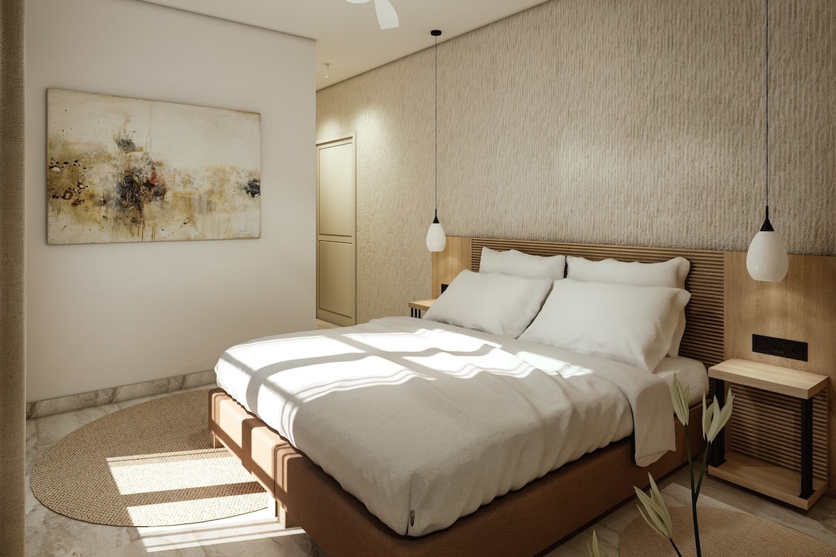 A modern bedroom with a large bed, two bedside tables, a ceiling fan, and a textured wall.