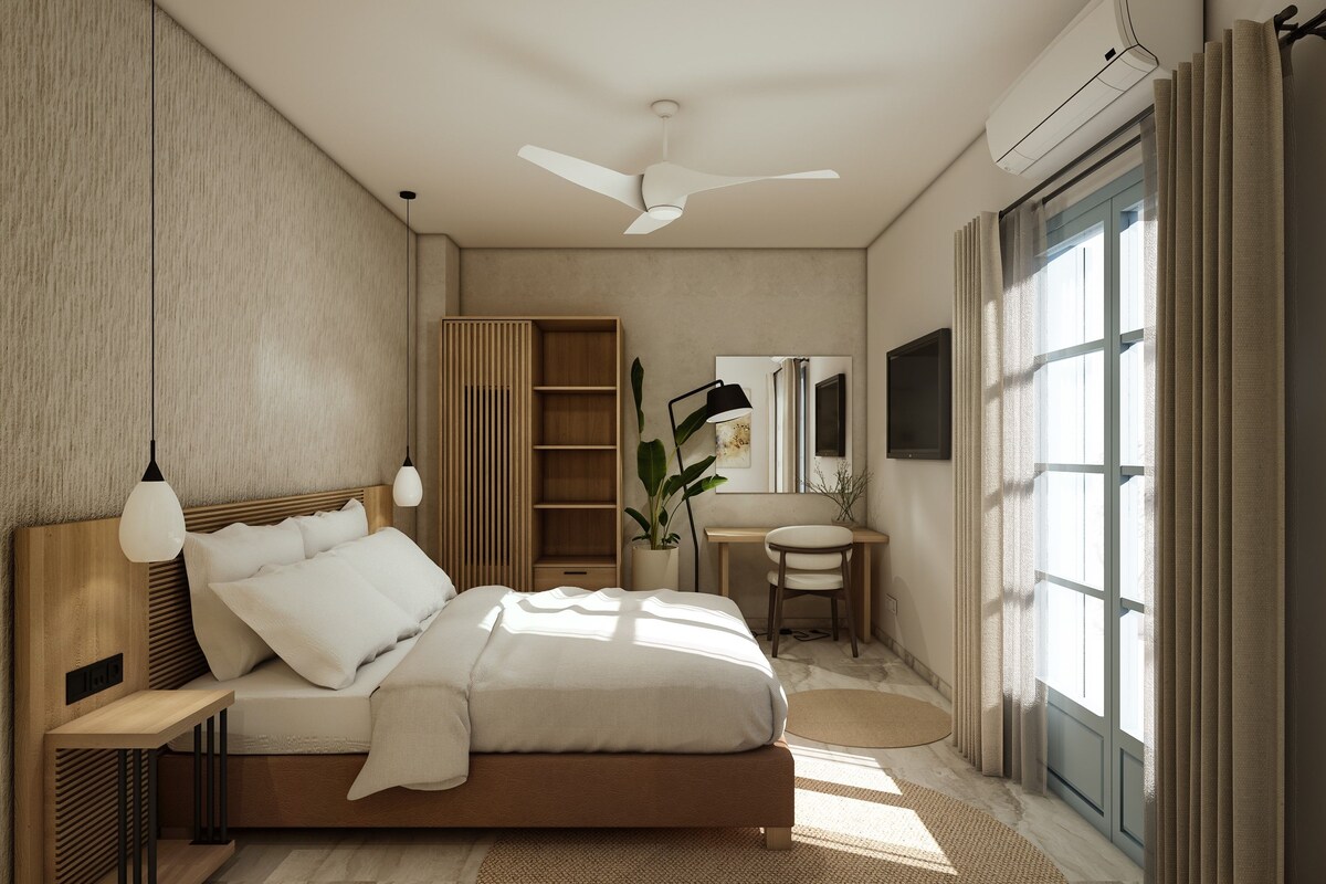 A modern bedroom with a bed, bedside tables, a desk, a chair, a mirror, and a large window with curtains.