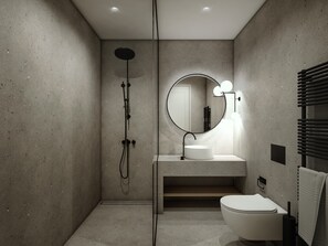 A modern bathroom with a freestanding sink, a round mirror with lights, a toilet, and a shower.