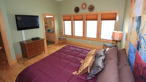 A bedroom with a bed, a TV, a dresser, a chair, and a window with blinds. - Quiet Modern Luxury Home w/ Memory Foam Beds, FAST WiFi and Full Kitchen (Bridgewater)