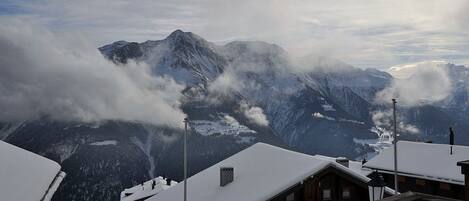 A mountain view with snow-covered roofs and a building labeled "ALPHA".