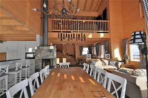 A spacious wooden cabin with a dining area, kitchen, and a loft bedroom. - Laackerhof (Bettmeralp)