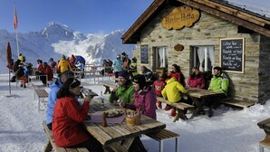 A wooden mountain hut named "Horti-Hitta" with stone walls and a signboard listing food and drink options. - Rupicapra (Bettmeralp)