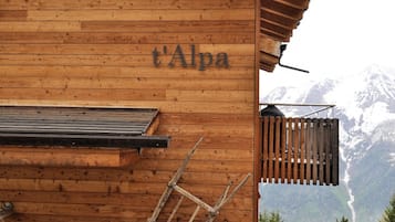 Un edificio de madera con el nombre 't'Alpa' en su fachada.