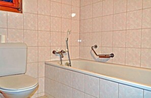 A bathroom with a toilet, a bathtub, and a shower. - Dorothy Sunshine (Fiesch)