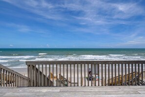 A wooden boardwalk leading to a beach with a clear view of the ocean. - 3952 Island Drive- Oceanfront Home with views and private beach access- Adjoining Side is Availab... (North Topsail Beach)