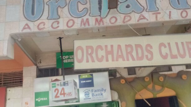 A building with signage for 'Orchard's Accommodation' and 'Orchards Club'. - Orchards Lodge (Naivasha)