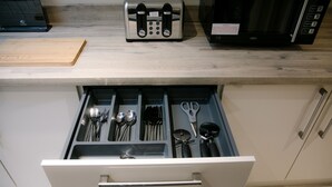 A kitchen drawer with utensils and a toaster. - Eske Holiday Apartment (Donegal Town)