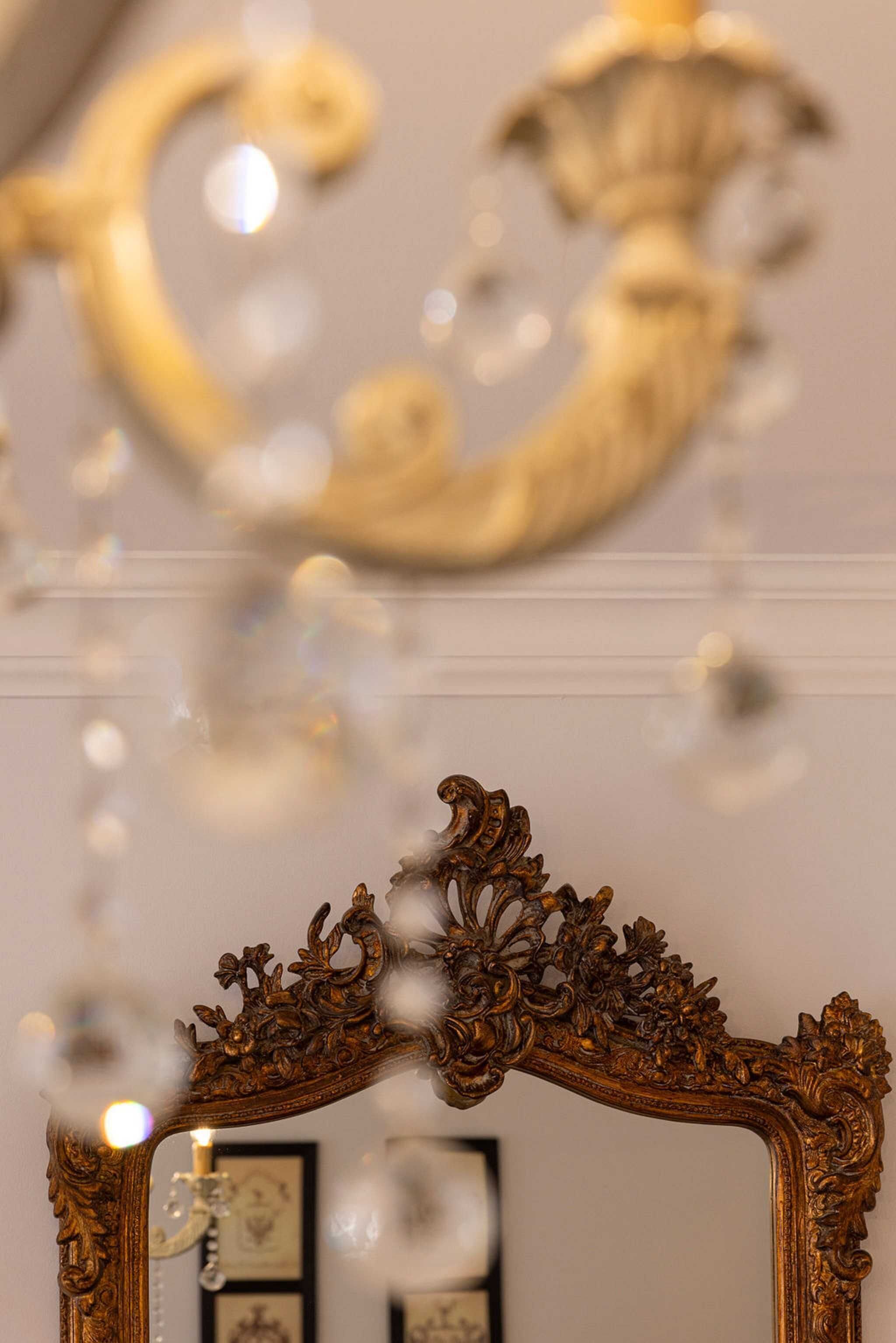 An ornate mirror with intricate floral carvings and a curved frame.
