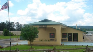 A small, single-story building with a green roof, labeled "Ozark Inn."