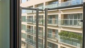 A modern apartment building with multiple balconies and large windows. - Still Life Old Street (London)