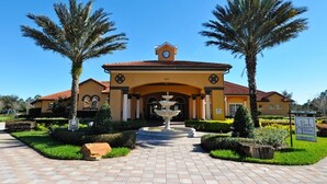 A building with a central fountain, palm trees, and a sign reading "Park Square Homes."
