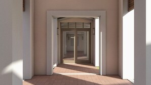 A corridor with a glass door leading to a room.