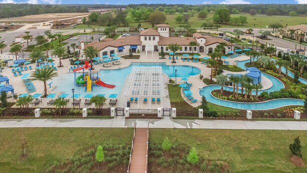A resort with a central pool, a water slide, and multiple lounge areas. - Luxury 5 Bedroom Private Pool IHR 1019 (Kissimmee)