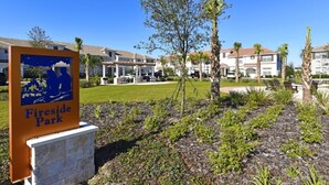 A Fireside Park sign with a clear view of residential buildings and a well-maintained lawn in the background.
