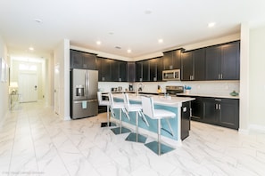 Villa (1581FD Champions Gate Resort Home ) | Private kitchen | Fridge, microwave, cookware/dishes/utensils, dining tables