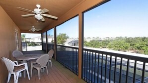 A balcony with a table and chairs, a ceiling fan, and a view of a residential area. - 110 Esspl (Davenport)