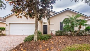 A residential house with a garage, a front door, and a driveway. - West Haven IHR 4079 (Davenport)