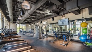 A gym with treadmills, weight machines, and exercise balls. - Amazing 6 Bedroom 5 Bathroom Solara Resort Villa (Kissimmee)