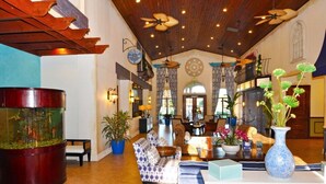 A spacious lobby with a large aquarium, comfortable seating, and decorative plants. - Paradise Palms IHR 3029 (Kissimmee)