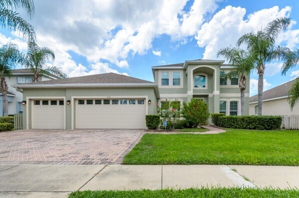 A two-story house with a garage, a driveway, and a well-maintained lawn. - 337 Belfry (Davenport)