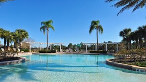 A clear swimming pool with a pergola structure, palm trees, and lounge chairs. - Watersong Resort - 7 Bed - Private Pool - IHR 3097 (Davenport)