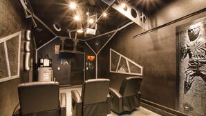 A room with three reclining chairs, a ceiling with recessed lighting, and a large wall mural. - 6 Bed 5 Ba Villa with Games, Pool & Spa (Kissimmee)