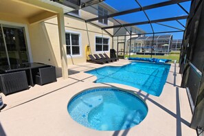A covered outdoor swimming pool with lounge chairs and a hot tub. - Highlands Reserve IHR 4071 (Davenport)