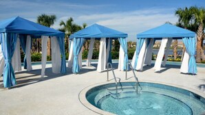 A pool area with three blue and white canopies and a central pool with a ladder. - Ultimate New 8 Bedroom 6 Bathroom Windsor (Kissimmee)