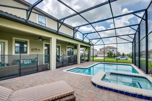 A covered outdoor area with a swimming pool, seating, and a view of the neighborhood. - 1314bw00 (Davenport)