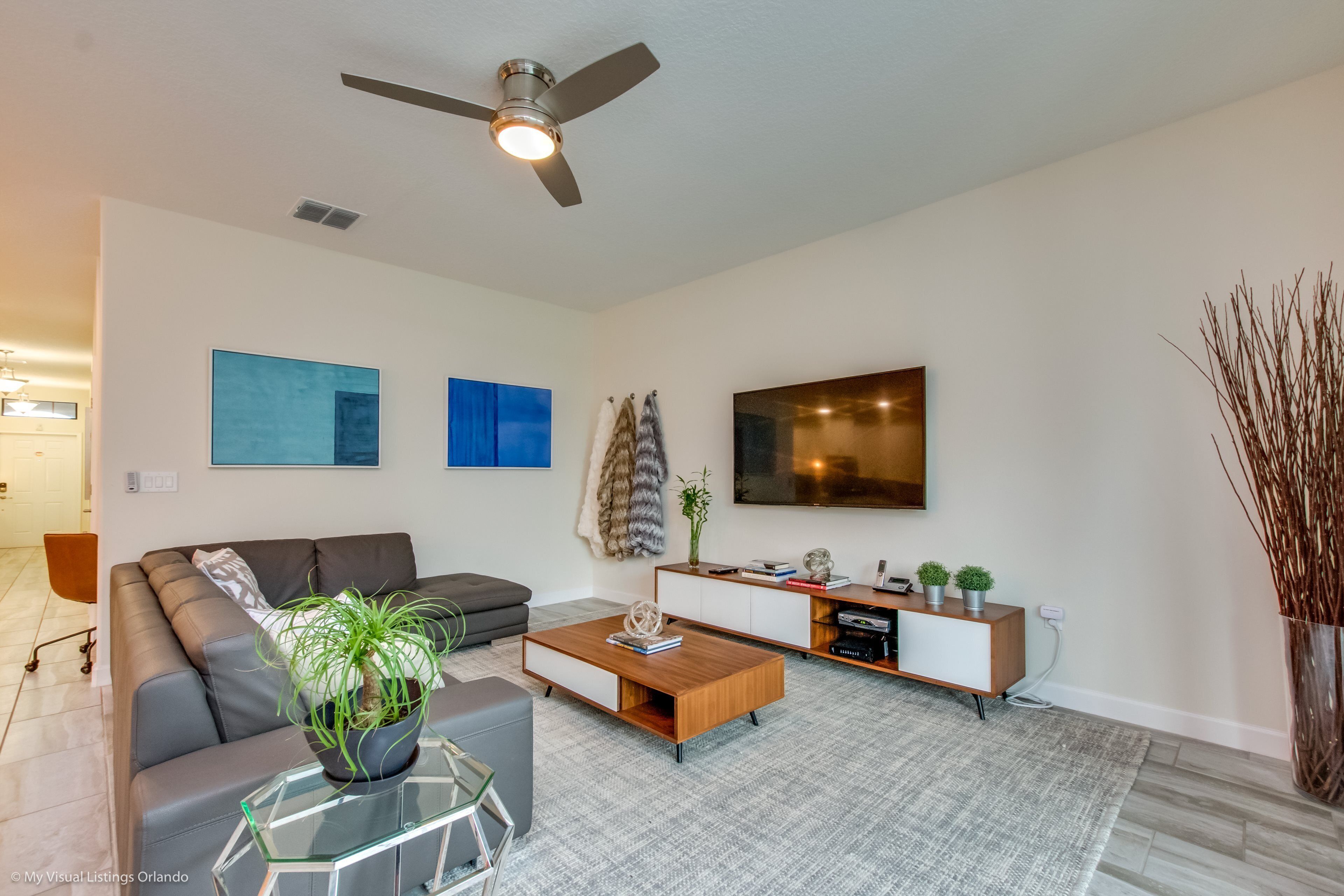 A modern living room with a sofa, coffee table, and TV.