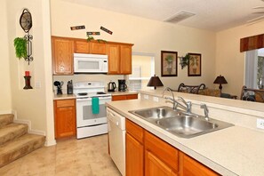 Villa | Private kitchen | Fridge, microwave, cookware/dishes/utensils