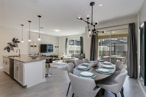 Enjoy meals and social gatherings in the spacious dining area with a central island.