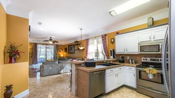 Villa | Private kitchen | Fridge, microwave, cookware/dishes/utensils, dining tables