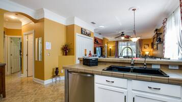 Villa | Private kitchen | Fridge, microwave, cookware/dishes/utensils, dining tables