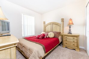 A bedroom with a bed, bedside tables, a lamp, and a window. - 734lam Regal Palms Town Home (Davenport)