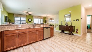 A kitchen with a granite countertop, wooden cabinets, and a dishwasher. - 1308cw00 (Davenport)