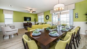 A dining area with a long wooden table set for six, surrounded by yellow chairs. - 1308cw00 (Davenport)