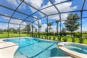A swimming pool with a clear view of the surrounding landscape through a transparent roof structure. - 14 Bdrm 11 Bath Villa For 30 (Davenport)